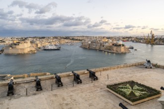 Beautiful sunset view of Valletta with a cannons in the foreground, capital city of Malta