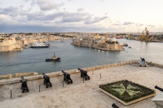 Beautiful sunset view of Valletta with a cannons in the foreground, capital city of Malta