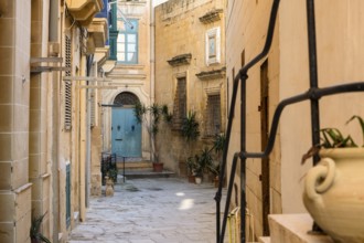 Street with amazing, wonderful historic houses with blue wooden balconies in La Valletta, capital