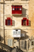 Amazing, wonderful historic houses with red wooden balconies in La Valletta, capital city of Malta