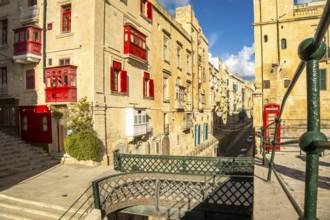 Street with incredible historic houses with colorful wooden balconies in La Valletta, capital city