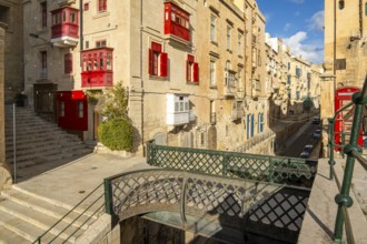 Street with incredible historic houses with colorful wooden balconies in La Valletta, capital city
