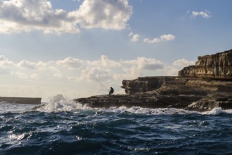 Coast with fishermen next to Marsaxlokk, southern part of Malta