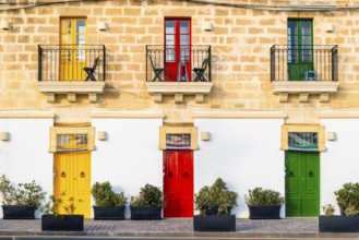Limestone building with colorful doors in Marsaxlokk, fisherman village on Malta