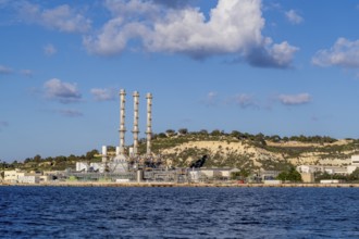 Waterfront power station against blue sky, with copy space, near to Marsaxlokk, Malta