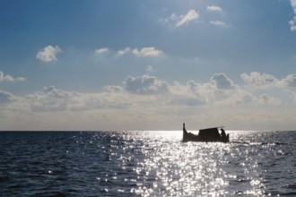 Silhouette of Maltese boat on Mediterranean Sea by Marsaxlokk, south of Malta