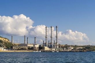 Waterfront power station against blue sky, with copy space, near to Marsaxlokk, Malta