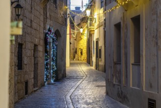 Charming illuminated medieval streets of Rabat Mdina in the evening Malta