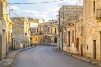 Charming street between limestone building in Nadur, Gozo island, Malta