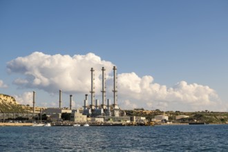 Waterfront power station against blue sky, with copy space, near to Marsaxlokk, Malta