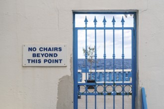 Blue locked door with sign No chairs beyond this point, Malta