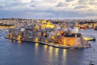 Beautiful evening view of illuminated Valletta, Birgu with Saint Angelo Fortress, capital city of