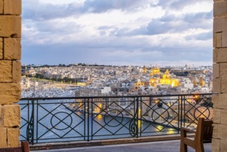 Beautiful evening view of illuminated Valletta, Birgu with Saint Angelo Fortress, capital city of