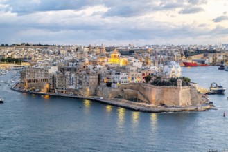 Beautiful evening view of illuminated Valletta, Birgu with Saint Angelo Fortress, capital city of