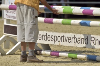 Erecting an obstacle course at an equestrian event, Rhineland-Palatinate, Germany