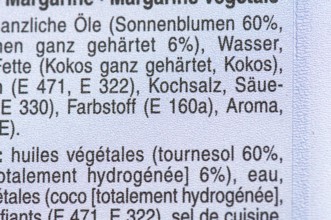 List of ingredients on a packet of margarine. Focus on coconut and E additives