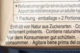 List of ingredients on a carton of oat milk. Focus on indication of sugar content