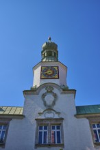Tower clock on a historic building under a clear blue sky. Impressive baroque architecture,