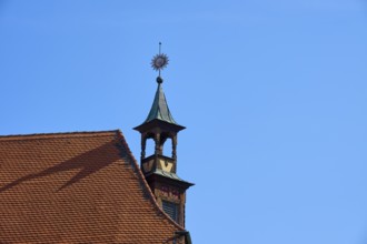Historic rooftop with tower and weather vane under a clear sky, Regensburg, Bavaria, Germany