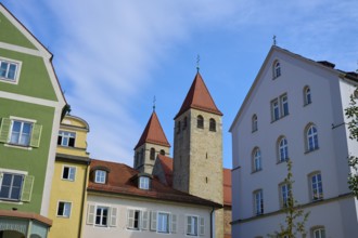 Historic buildings with red roofs and church towers under a blue sky, Regensburg, Bavaria, Germany