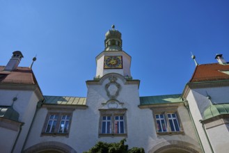 Historic building with tower and clock under a radiant sky. Baroque details and symmetrical design,