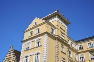 Historic building with yellow façade and decorative elements, Regensburg, Bavaria, Germany