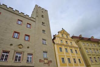 Historic buildings with medieval tower under a cloudy sky in Regensburg, Regensburg, Bavaria,