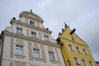 Detailed view of decorated facades of historic buildings under a cloudy sky, Regensburg, Bavaria,