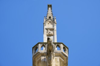 Detail of a Gothic spire with sculptures in the blue sky, St Peter's Cathedral, Regensburg,