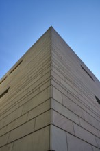 Modern architecture with clear lines and geometric shapes, hit by sunlight under a blue sky,