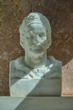 White marble bust of Jakob Fugger in front of a reddish wall, Walhalla, Donaustauf, Regensburg,