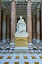 White statue of Ludwig I, surrounded by red marble columns and magnificent floor pattern, Walhalla,