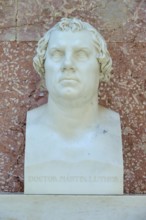 White marble bust of Martin Luther in front of a reddish wall, Walhalla, Donaustauf, Regensburg,
