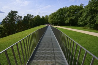 A metal bridge leads symmetrically towards a green wooded area, Walhalla, Donaustauf, Regensburg,