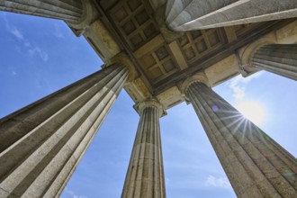 Imposing columns against a bright blue sky with a view of the sun, Walhalla, Donaustauf,