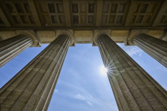 Classical stone pillars rise into the sky, pierced by rays of sunlight, Walhalla, Donaustauf,