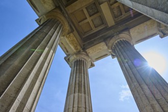 Three massive columns rise up against the blue sky, seen from below, Walhalla, Donaustauf,