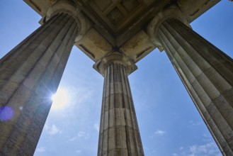 Majestic columns under a bright blue sky, seen from a low perspective, Walhalla, Donaustauf,