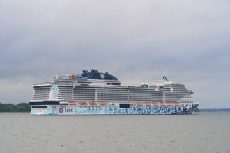 Large cruise ship, MSC Euribia, in calm waters under a cloudy sky, Heikendorf, Plön district, Kiel