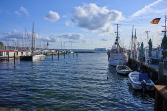 Harbour view with moored boats and blowing wind under a blue sky, Heikendorf, Plön district, Kiel