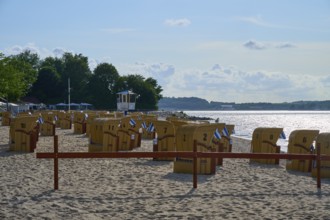 Beach chairs on a quiet beach with blue sky and water in the background under the summer sun,