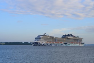 Cruise ship, MSC Euribia, gliding along in front of a wide water landscape, Heikendorf, Plön