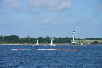 Scene at the sea with several boats and a lighthouse in the background, lighthouse Friedrichsort,