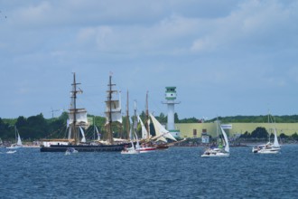 Large traditional sailing ship surrounded by sailing boats on the sea near Friedrichsort