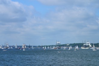 Boats and sailing ships sailing on the sea under a slightly cloudy sky, Windjammer Parade Kiel