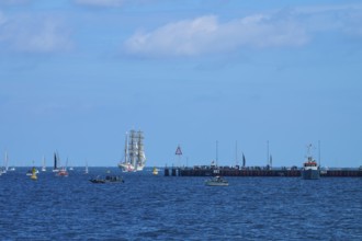 A sailing ship Gorch Fock in the distance, various boats and a jetty in the picture, Windjammer