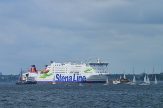 Stena Line ferry on the sea with sailing boats in the surroundings and a cloudy sky, Windjammer