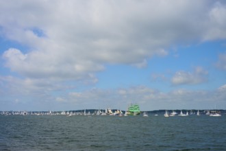 Numerous sailing boats on the sea under a slightly cloudy sky, Windjammer Parade Kiel 2025,