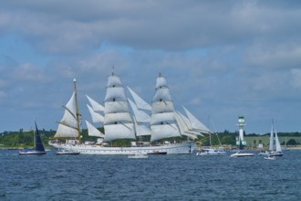 Large sailing ship Gorch Fock with several white sails on the sea under a blue sky, Windjammer