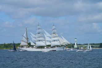 White sailing ship Gorch Fock on the sea with several big sails under blue sky, Windjammer Parade